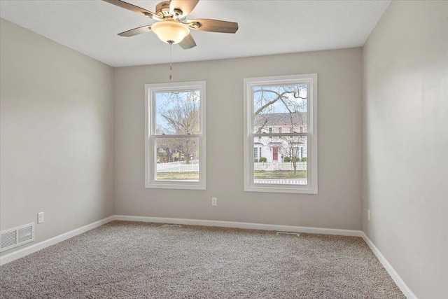 1980 W Forest Ave, Decatur, IL 62522 - spare room featuring visible vents, baseboards, a ceiling fan, and carpet