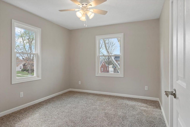 1980 W Forest Ave, Decatur, IL 62522 - carpeted empty room featuring ceiling fan, baseboards, and plenty of natural light