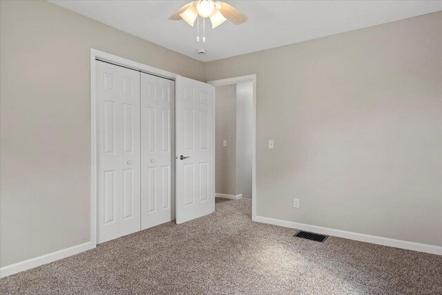 1980 W Forest Ave, Decatur, IL 62522 - unfurnished bedroom featuring a closet, baseboards, visible vents, ceiling fan, and carpet