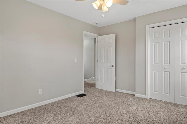 1980 W Forest Ave, Decatur, IL 62522 - unfurnished bedroom with a closet, baseboards, visible vents, ceiling fan, and carpet