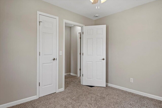 1980 W Forest Ave, Decatur, IL 62522 - unfurnished bedroom with ceiling fan, light colored carpet, and baseboards