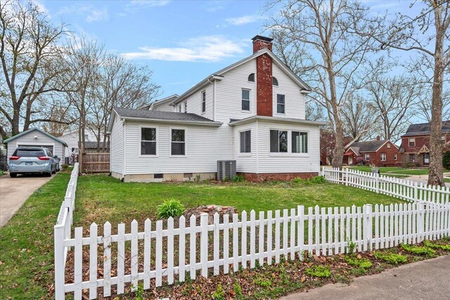 1980 W Forest Ave, Decatur, IL 62522 - view of front facade featuring a chimney, a fenced front yard, a front lawn, and an outbuilding