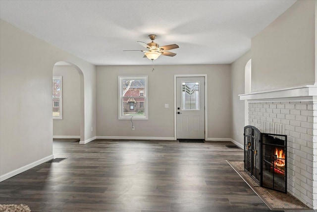 1980 W Forest Ave, Decatur, IL 62522 - unfurnished living room featuring visible vents, ceiling fan, a brick fireplace, and baseboards