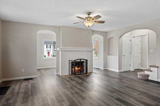 1980 W Forest Ave, Decatur, IL 62522 - unfurnished living room with visible vents, baseboards, a brick fireplace, a ceiling fan, and wood finished floors
