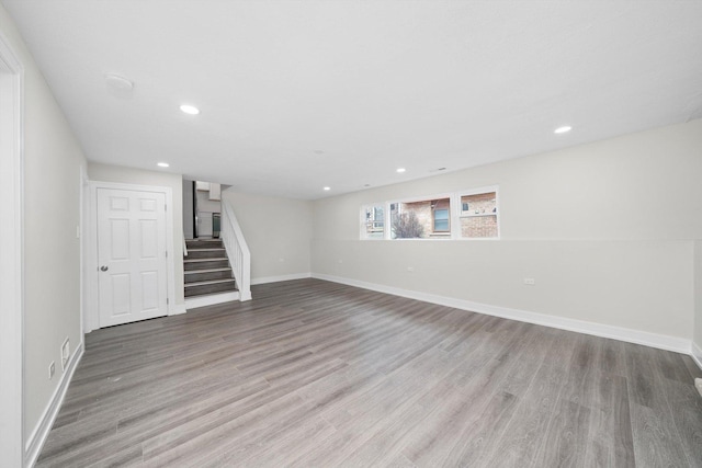 below grade area featuring recessed lighting, visible vents, light wood-type flooring, baseboards, and stairs