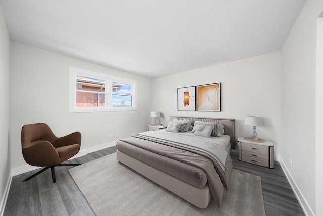 bedroom with wood finished floors and baseboards