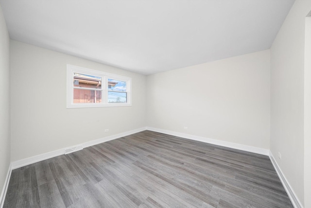 empty room with wood finished floors and baseboards