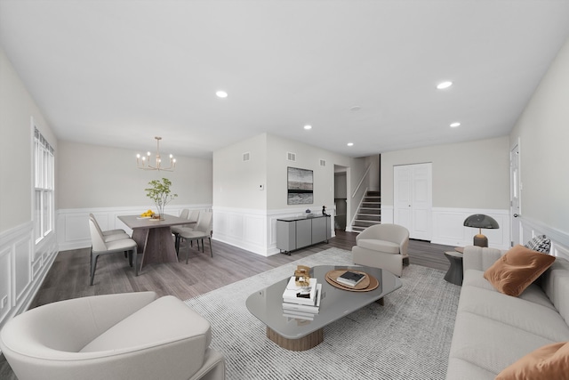 living area featuring wood finished floors and wainscoting