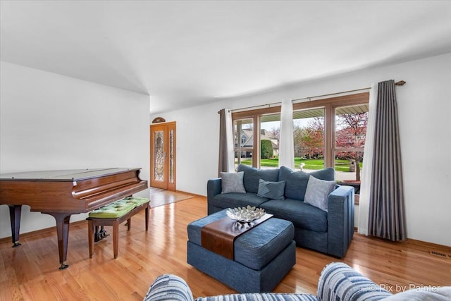living room featuring visible vents and light wood-type flooring