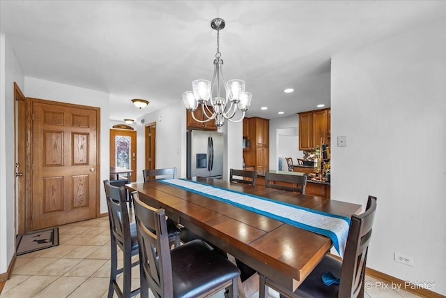 dining space featuring a chandelier, recessed lighting, light tile patterned floors, and baseboards