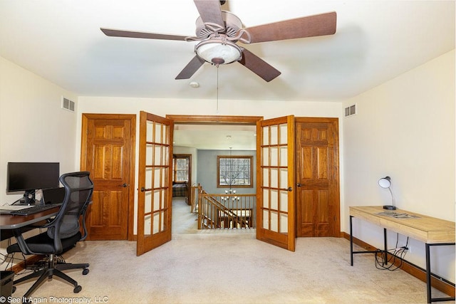 home office featuring carpet flooring, a ceiling fan, visible vents, and french doors