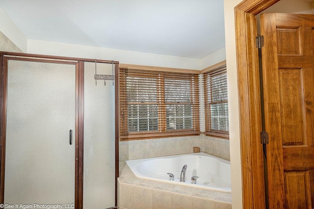 full bathroom with a whirlpool tub and a stall shower