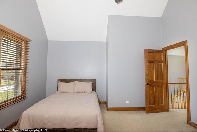 bedroom featuring baseboards, carpet floors, and lofted ceiling