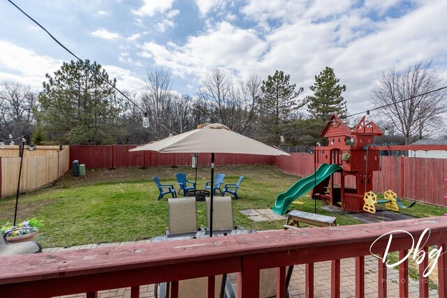 view of playground featuring a fenced backyard and a yard