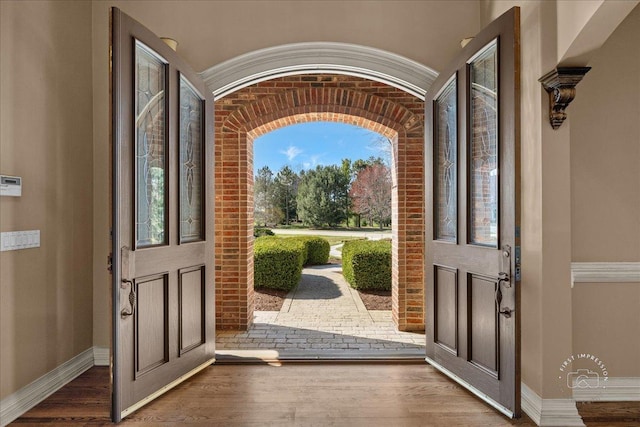entrance foyer featuring wood finished floors and baseboards