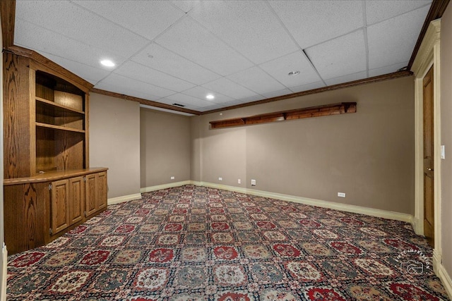 finished below grade area featuring a paneled ceiling, baseboards, carpet, and recessed lighting