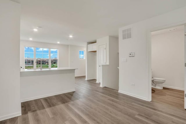 363 Bridgeview Ct, Saint Charles, IL 60174 - spare room with visible vents, baseboards, a sink, recessed lighting, and wood finished floors