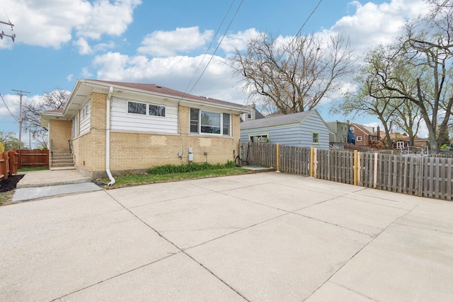 exterior space with fence and brick siding