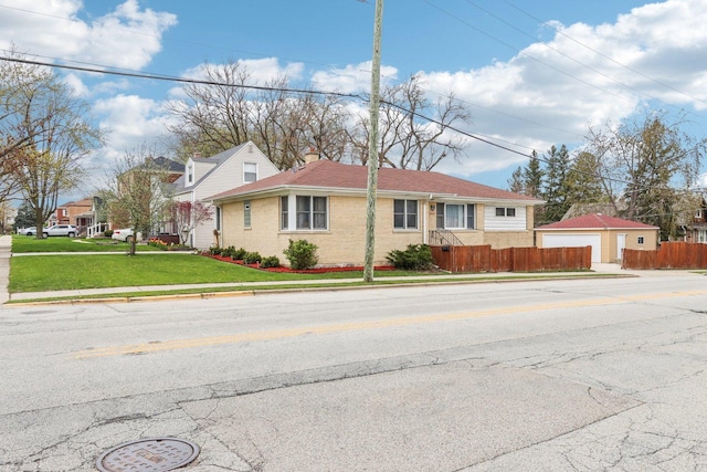 view of front of property featuring a chimney, fence, brick siding, a front lawn, and a garage