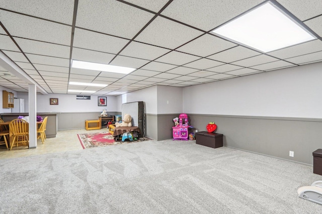 game room with a paneled ceiling and carpet flooring
