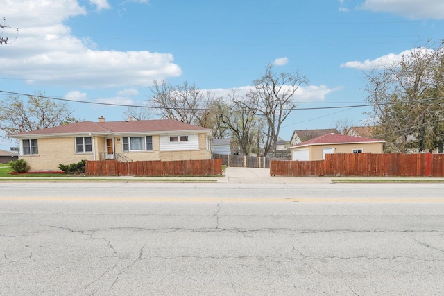 single story home featuring brick siding, fence private yard, and a chimney