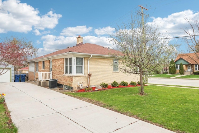 view of property exterior featuring an outdoor structure, concrete driveway, a chimney, a yard, and brick siding