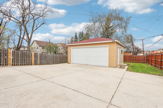 detached garage featuring fence
