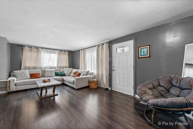 living room with baseboards and dark wood-style floors