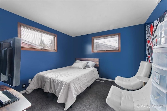 carpeted bedroom with baseboards and multiple windows