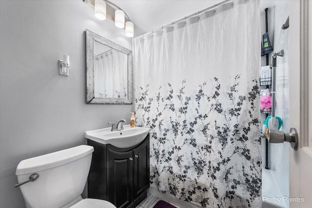 bathroom with vanity, curtained shower, and toilet