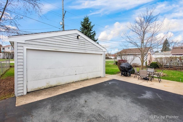 detached garage featuring fence