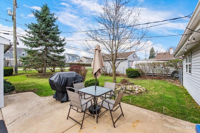 view of patio featuring fence, grilling area, and outdoor dining space