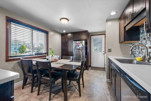 dining room with recessed lighting and baseboards