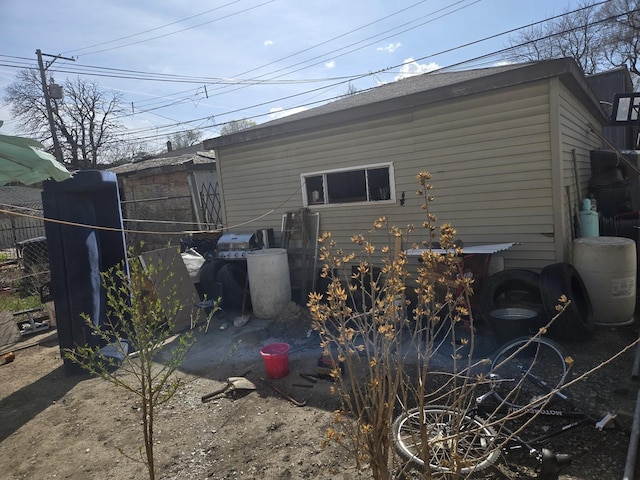 rear view of house featuring fence