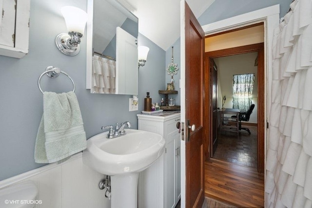 bathroom featuring a sink and vaulted ceiling