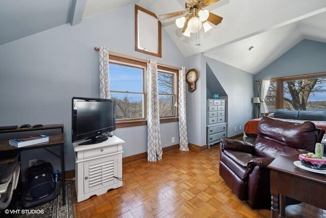 interior space with baseboards, a ceiling fan, and lofted ceiling