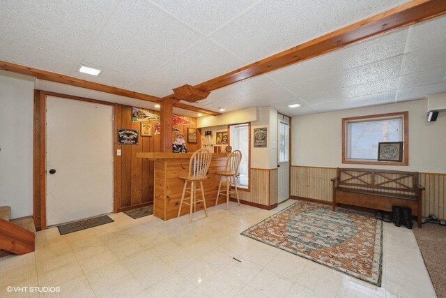 reception area with a bar and stairway