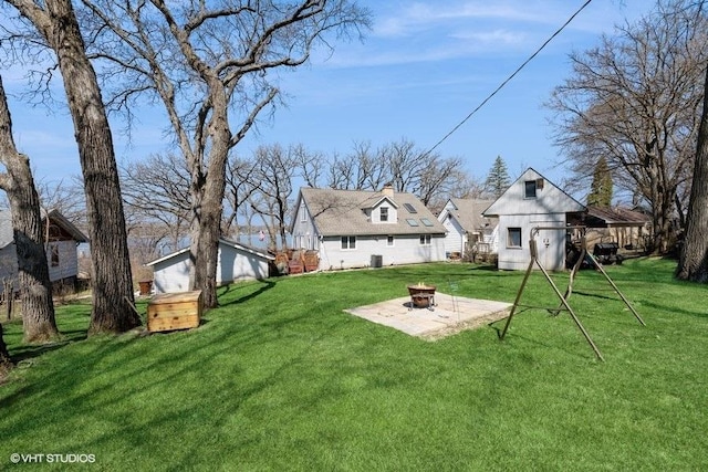 view of yard featuring a fire pit and an outbuilding