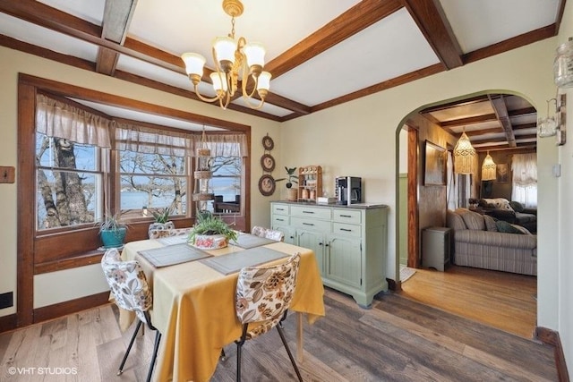 dining area with a notable chandelier, dark wood-style flooring, beam ceiling, coffered ceiling, and arched walkways