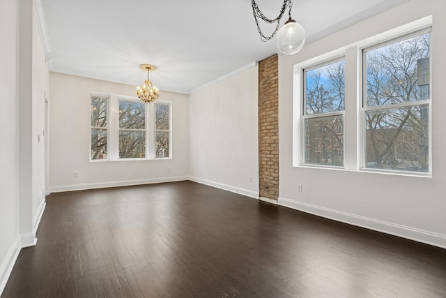 unfurnished dining area with dark wood-type flooring, baseboards, a chandelier, and crown molding