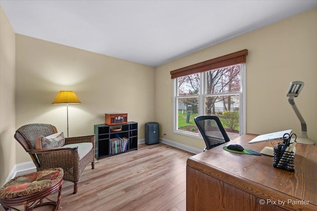 office with baseboards and light wood-style flooring