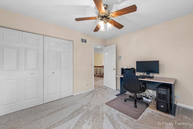carpeted office with baseboards, a ceiling fan, and visible vents