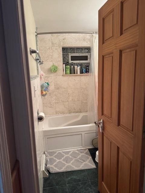 full bathroom with shower / bath combo and toilet