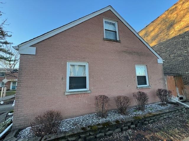 view of property exterior with brick siding