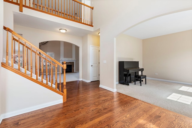 1866 Snead St, Bolingbrook, IL 60490 - interior space with arched walkways, a tiled fireplace, wood finished floors, and a towering ceiling