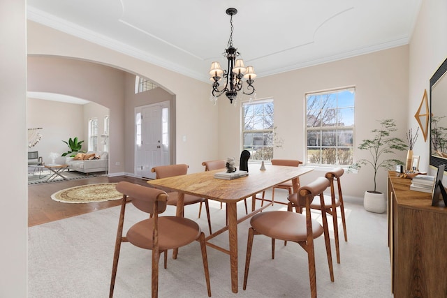 1866 Snead St, Bolingbrook, IL 60490 - dining space featuring light colored carpet, arched walkways, a chandelier, and ornamental molding