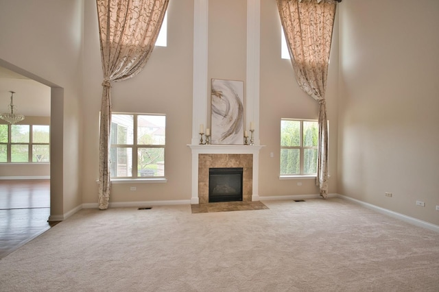 1866 Snead St, Bolingbrook, IL 60490 - unfurnished living room featuring a tiled fireplace, carpet flooring, baseboards, and a high ceiling