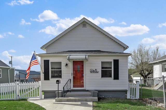 view of front facade featuring a gate, fence, a front yard, and entry steps