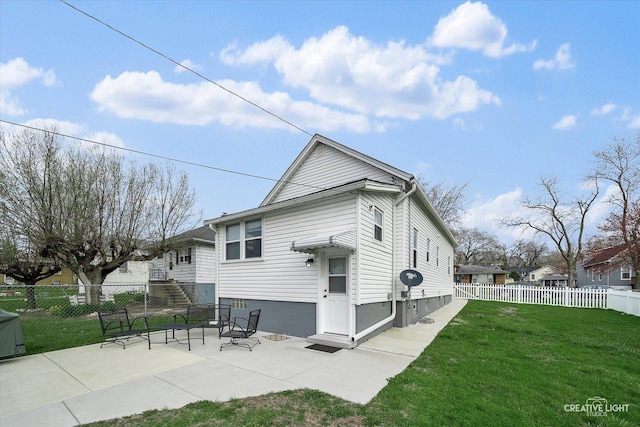 rear view of property featuring fence, a patio, and a yard