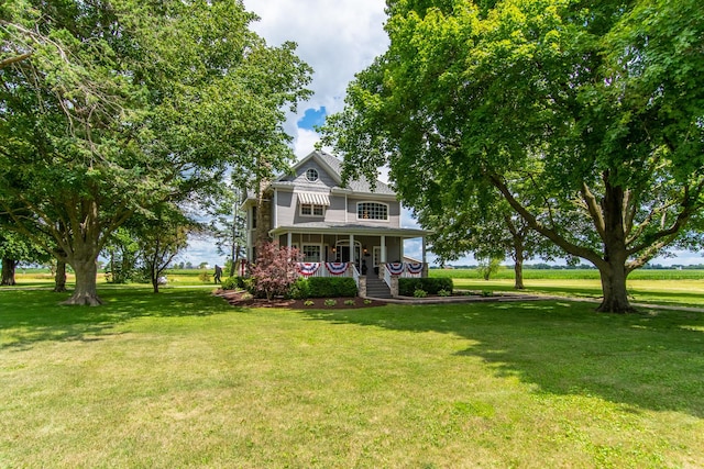victorian house featuring a front yard and covered porch